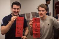 Alexander (right) writes Fai Chun to celebrate Chinese New Year